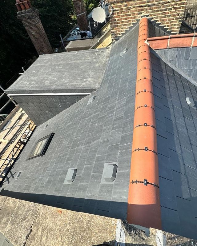 Slate roof with new clay ridge tiles