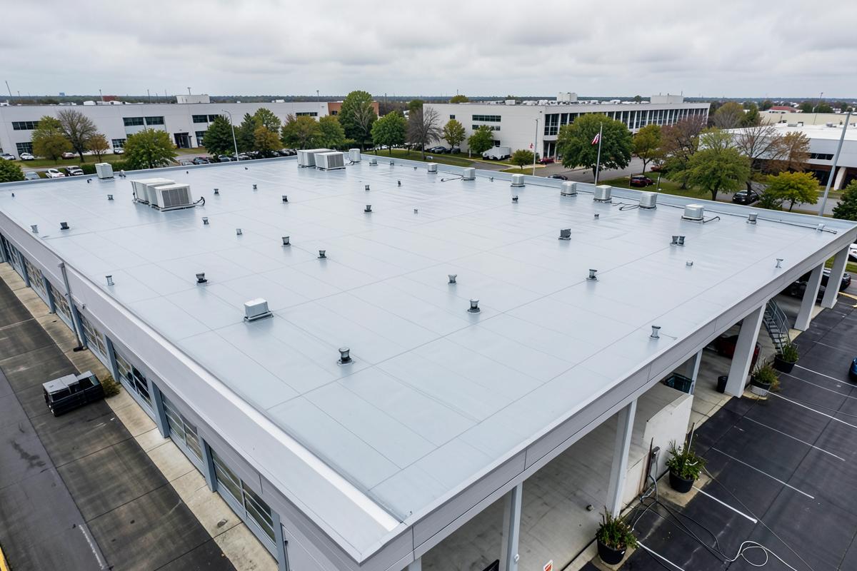 Large commercial flat roof with membrane covering and roof outlets