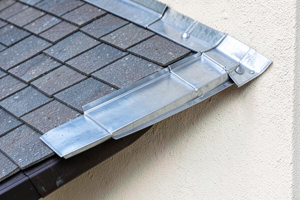 Lead flashing dressed where a pitched roof meets a rendered wall